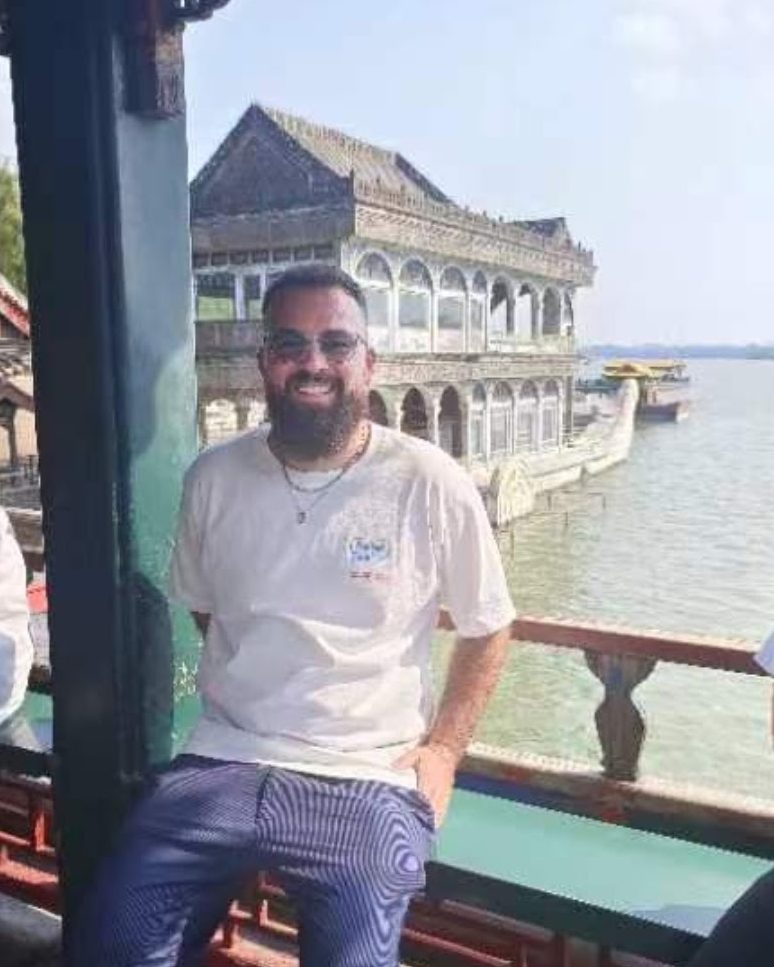 Teacher Reed at the Summer Palace with the Marble Boat behind him