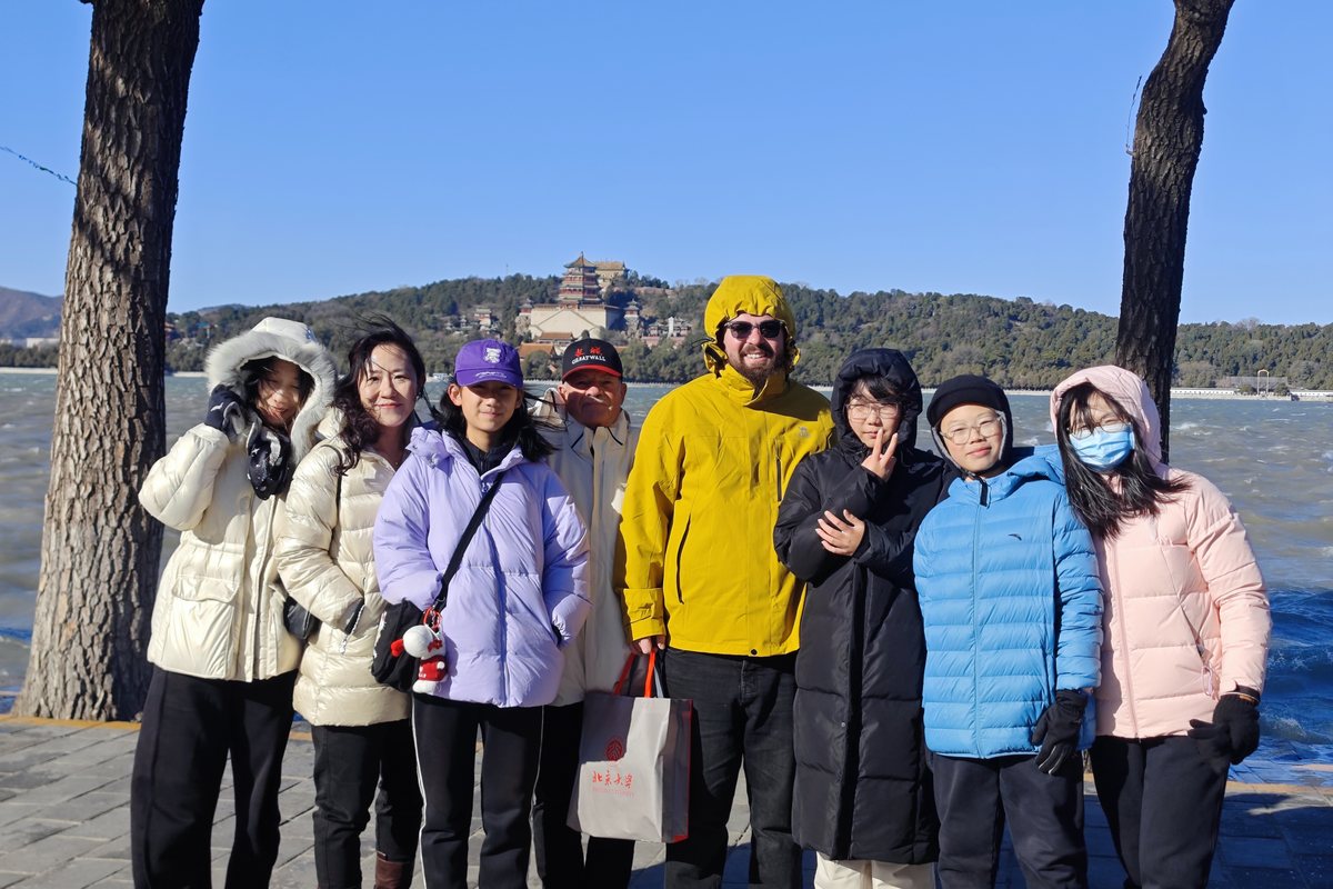 Teacher Reed with a group by the lake at the Summer Palace in winter