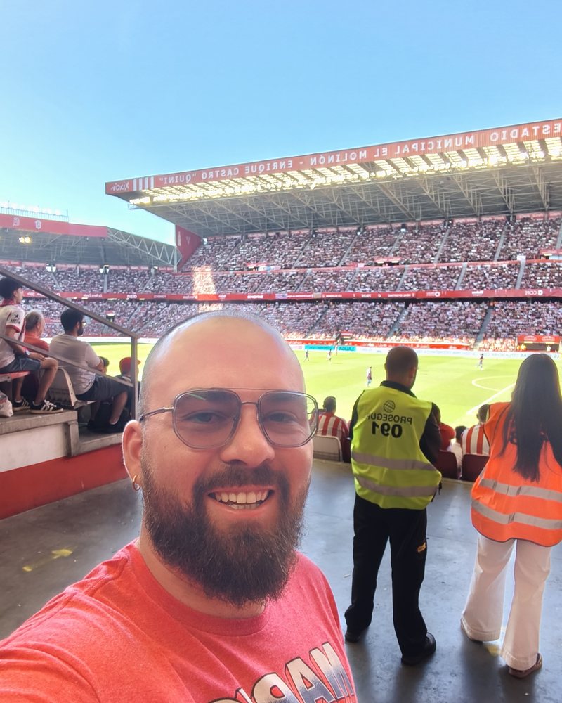 Teacher Reed at a football match in a stadium in Gijón, Spain